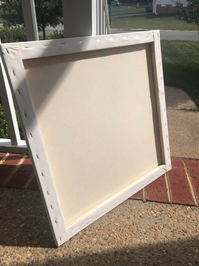 May include: A white canvas stretched over a wooden frame. The canvas is blank and ready for painting.
