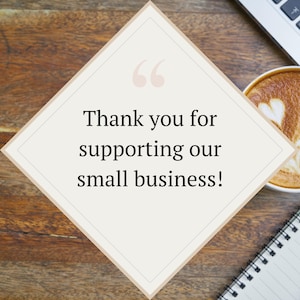 May include: A diamond-shaped card with the text "Thank you for supporting our small business!" is displayed on a wooden surface. A cup of coffee with latte art and a notebook are also visible.