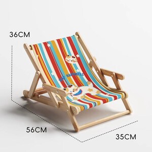 May include: A small, wooden folding beach chair with a colorful striped fabric seat. The seat features a cartoon dog and the words "FOR HAPPINESS". The chair measures 22 inches long, 14 inches wide, and 13 inches high.