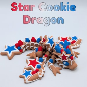 May include: A whimsical Star Cookie Dragon sculpture. The dragon is made of star-shaped cookies, decorated with red, white, and blue accents. The text "Star Cookie Dragon" is displayed above the sculpture in a gradient color scheme.