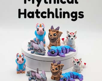 May include: A collection of colorful, handcrafted figurines of mythical creatures, including dragons, unicorns, and fox-like beings. The figurines are in various poses and colors, with the text "Mythical Hatchlings" at the top.