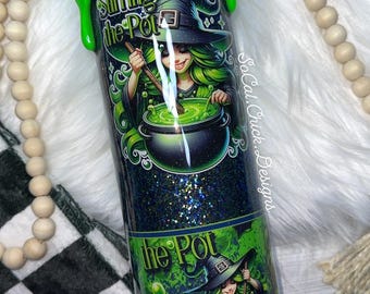 May include: A glittery tumbler with a green witch illustration stirring a bubbling cauldron. The tumbler has a green, dripped-paint effect on the top and the words "Stirring the Pot". The design is set against a dark blue background.