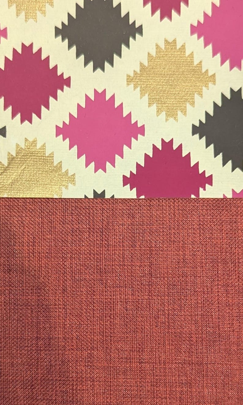 May include: A two-part surface featuring a top section with a repeating pattern of jagged-edged diamond shapes in magenta, metallic gold, and dark grey on a cream background, paired with a bottom section of solid, textured, dark terracotta fabric.