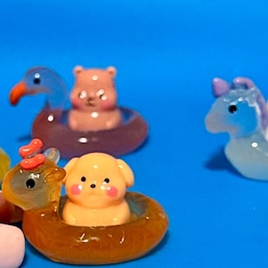 May include: A set of three ceramic mugs with a speckled, matte finish. The mugs are in shades of cream, light gray, and dark gray. Each mug has a simple, minimalist design, perfect for coffee or tea.