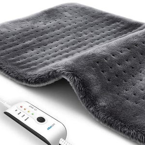 May include: A gray, plush heating pad with a control panel. The pad has a textured surface with small holes. The control panel has buttons and indicator lights for different heat settings. The brand name "4Bancare" is visible on the control panel.