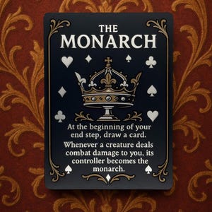 May include: A black card with gold and white accents, featuring the text "THE MONARCH" and a crown illustration. The card includes instructions and suit symbols, set against a patterned background.