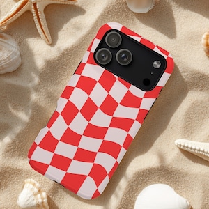 May include: A rectangular smartphone case featuring a vibrant red and white wavy checkerboard pattern. The case has a black camera module cutout at the top, revealing three circular camera lenses and a flash, designed to fit a modern mobile device.