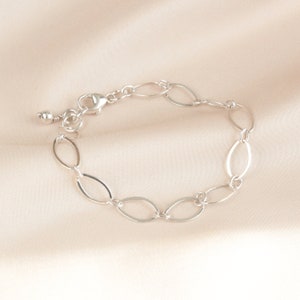 May include: A silver chain bracelet with oval links. The bracelet has a lobster clasp.