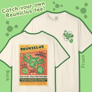 May include: Off-white tee shirt with a graphic on the front and back. The front has a small green design. The back features a colorful graphic with the text "REUNICLUS HAS EVOLUTIONARY ENERGY!" and "Catch your own Reuniclus tee!"
