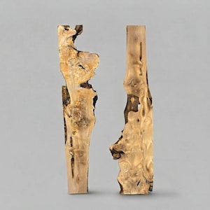 May include: Two tall, vertical wooden sculptures with natural, irregular edges and a light tan finish. The wood grain is visible throughout, featuring dark brown knots, organic curves, and hollowed-out sections that create a unique, textured appearance.
