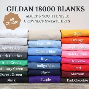 May include: A selection of Gildan 18000 unisex crewneck sweatshirts in a range of colours, including white, black, and navy. The image shows the available colours, such as light pink, orange, and maroon. Text on the image reads "GILDAN 18000 BLANKS" and "ADULT & YOUTH UNISEX CREWNECK SWEATSHIRTS."