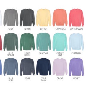 May include: A selection of Comfort Colors 1566 unisex garment-dyed crewneck sweatshirts in a range of colours. Shades include white, grey, pepper, butter, terracotta, watermelon, crimson, blue spruce, light green, seafoam, chalky mint, chambray, flo blue, blue jean, denim, true navy, orchid, and violet.