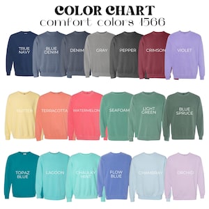 May include: A colour chart of Comfort Colors 1566 sweatshirts in various hues. The sweatshirts are displayed in rows, showcasing colours like True Navy, Blue Denim, Grey, Crimson, and Violet. Other colours include Butter, Terracotta, Seafoam, and Topaz Blue.