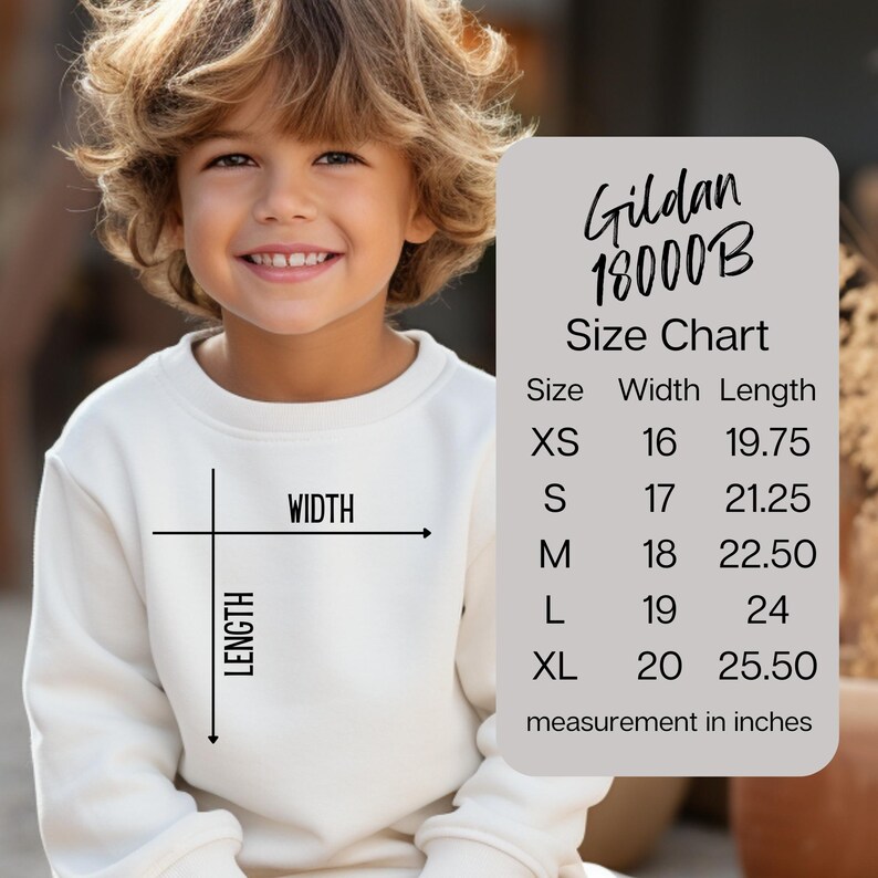 May include: A cream-coloured sweatshirt with a size chart graphic. The chart, labelled "Gildan 18000B," lists sizes XS to XL with width and length measurements in inches. The sweatshirt has a crew neck and long sleeves.
