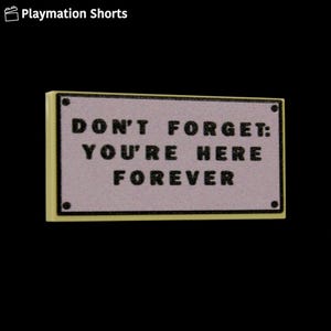 May include: A rectangular sign with the text "DON'T FORGET: YOU'RE HERE FOREVER" in black letters. The sign has a light purple background and a yellow border. The sign is against a black background.