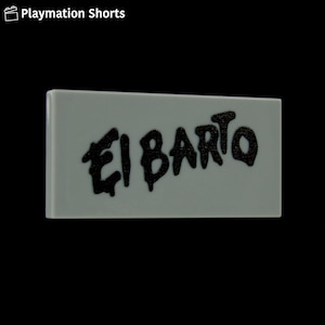 May include: A rectangular, light gray tile with the words "El Barto" in black, graffiti-style lettering. The tile is set against a black background. The words are stylized and bold.