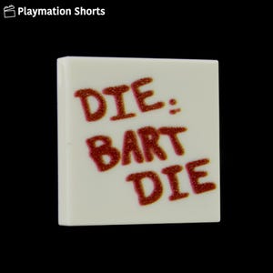 May include: A square, off-white tile with the words "DIE: BART DIE" in glittery red lettering. The tile is set against a black background, with the text prominently displayed.