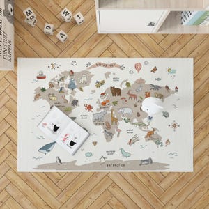 May include: A beige world map rug with illustrated animals, landmarks, and the text "WORLD MAP". A book and a white decorative object are on the rug. Wooden blocks and a shelf are in the background.