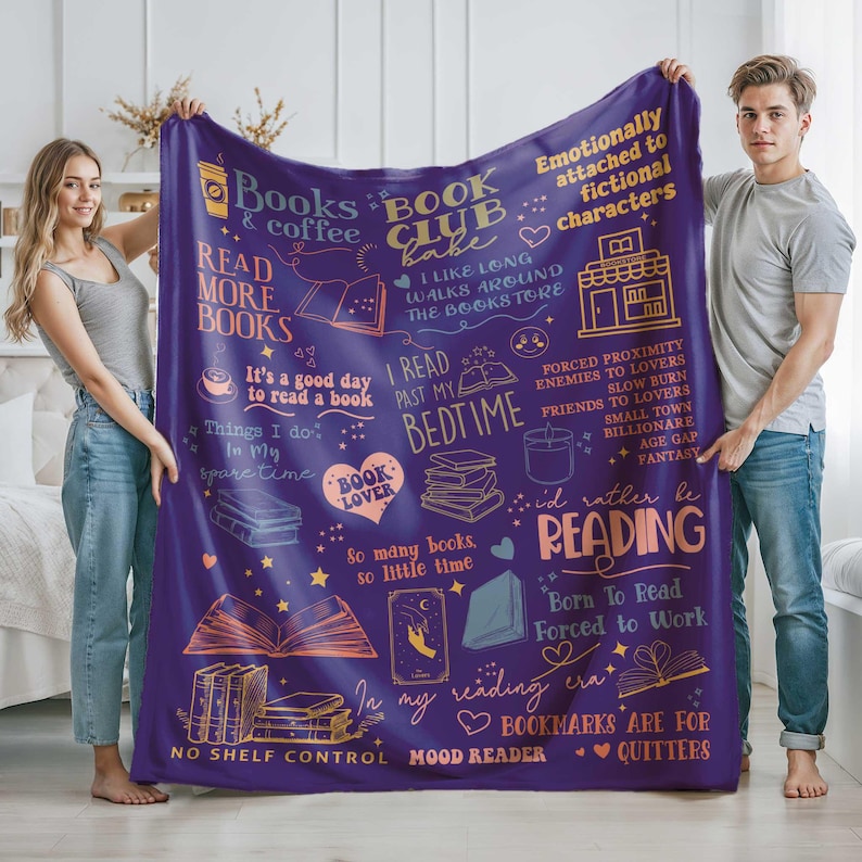 May include: A purple fleece blanket with various book-themed illustrations and phrases in white and orange. The blanket features text such as "Books & Coffee," "Book Club Babe," and "I'd rather be reading."