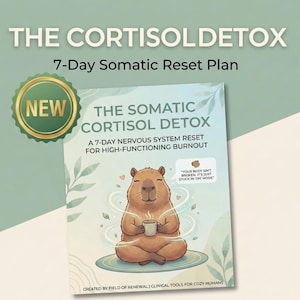 May include: A book cover titled "THE CORTISOL DETOX" with a cartoon capybara meditating and holding a mug. The cover also includes the text "7-Day Somatic Reset Plan" and "A 7-DAY NERVOUS SYSTEM RESET FOR HIGH-FUNCTIONING BURNOUT". The book is labeled "NEW".