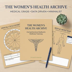 May include: A collection of medical and wellness tracking journals. The journals are tan with black text, including "The Women's Health Archive" and "Skin & Mole Map." A blue pen and a small succulent are also present.