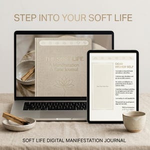 May include: A laptop and tablet display a digital manifestation journal. The journal cover reads "THE SOFT LIFE" with a lotus flower illustration. The tablet shows a page titled "DEAR HIGHER SELF". The text "STEP INTO YOUR SOFT LIFE" and "SOFT LIFE DIGITAL MANIFESTATION JOURNAL" are also visible.