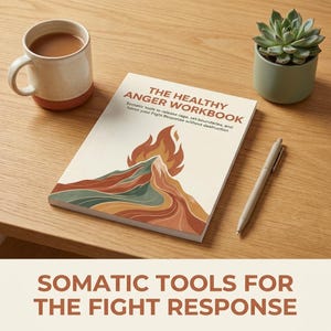 May include: A workbook titled "The Healthy Anger Workbook" with a mountain and flame design, a pen, a mug of coffee, and a succulent plant in a small pot on a wooden surface. The book's subtitle reads "Somatic tools to release rage, set boundaries, and honor your Fight Response without destruction."