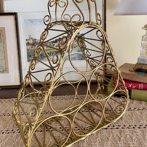 May include: A white ceramic mug with a black handle and the text "But First, Coffee" in a handwritten style. The mug is on a white surface. The mug is likely for hot beverages.