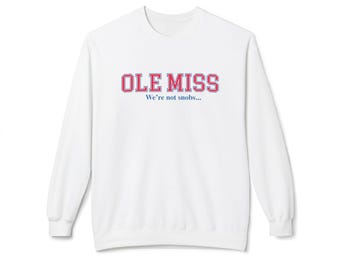 May include: White sweatshirt with the text "OLE MISS" in red and blue lettering. Below the text is the phrase "We're not snobs..." in blue. The sweatshirt has long sleeves and a crew neck.
