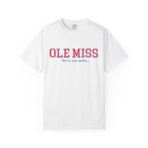 May include: White t-shirt with the text "OLE MISS" in red and blue block letters. Below the text is the phrase "We're not snobs..." in a smaller font. The shirt has a crew neck and short sleeves.