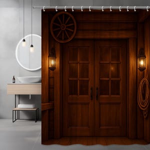 May include: A brown wooden shower curtain featuring a rustic design. The curtain depicts a double door with a wagon wheel above, flanked by lanterns. A rope coil hangs on the right side, creating a vintage, western theme.