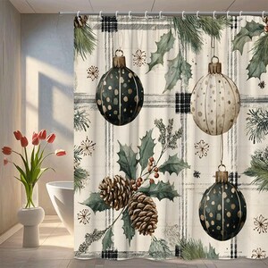 May include: A Christmas-themed shower curtain featuring a plaid pattern with hanging ornaments, pine cones, and holly leaves. The ornaments are dark green and cream-colored with dot patterns. The curtain has a neutral color palette with green and brown accents.