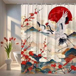 May include: A shower curtain featuring a Japanese-inspired design. The curtain depicts two white cranes in flight against a backdrop of a red sun, clouds, and floral branches with red blossoms. The color palette includes shades of red, blue, and cream.