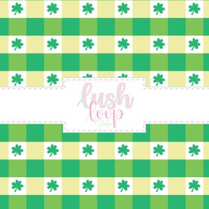 May include: A repeating pattern featuring a green and yellow checkered background with white shamrocks. The design includes a white rectangular space with the text "Lush Loop Studio" in a cursive font.