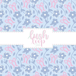 May include: A light blue floral pattern with gray flowers, pink bows, and green stems. The design includes the text "lush loop Studio" in a white rectangular box. The pattern is suitable for fabric or wallpaper.