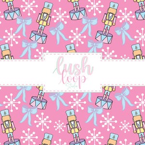 May include: A pink background with a repeating pattern of cartoon nutcrackers, bows, and snowflakes. The nutcrackers are in yellow, blue, and tan. The bows are light blue, and the snowflakes are white. The text "lush loop Studio" is in a white rectangle.