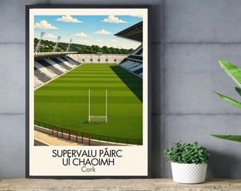 May include: A framed art print depicting a stadium with a vibrant green grass pitch, white goalposts, and tiered seating under a blue sky with clouds. The text at the bottom reads SUPERVALU PÁIRC UÍ CHAOIMH Cork in a clean, black sans-serif font.