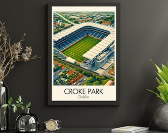 May include: A framed print featuring Croke Park stadium in Dublin, Ireland. The image shows an aerial view of the stadium with a green pitch, blue seating, and a white roof. The print is in a black frame and has the text "Croke Park Dublin".
