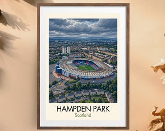 May include: A framed art print featuring an aerial view of Hampden Park stadium in Scotland. The image shows the stadium structure, the green pitch, and surrounding urban landscape under a cloudy sky. The text reads Hampden Park Scotland.