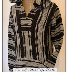 May include: A black and silver Baja hoodie with a hood and a front pocket. The crochet sweater has vertical stripes of black and silver. The text "Black & Silver Baja Hoodie" is at the bottom of the image.