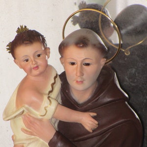 Antique image of Saint Anthony of Padua with the child Jesus,  from the 1940s.  Catholic religious statue with glass eyes.