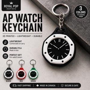 Op de afbeelding: AP Watch sleutelhangers in zwart, rood en groen. De sleutelhangers zijn 3D-geprint, lichtgewicht en duurzaam. De wijzerplaat is zwart met witte accenten. De tekst op de afbeelding luidt "AP WATCH KEYCHAIN" en "3 KLEUREN OM UIT TE KIEZEN".