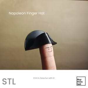 May include: A black miniature Napoleon hat, designed to fit on a finger, is displayed. The finger has a drawn-on face. The text "Napoleon Finger Hat" is at the top. The image also includes the text "STL" and "Print it, have fun with it!"