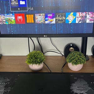 May include: A set of three ceramic mugs with a speckled, matte finish. The mugs are in shades of cream, light gray, and dark gray. Each mug has a simple, minimalist design, perfect for coffee or tea.