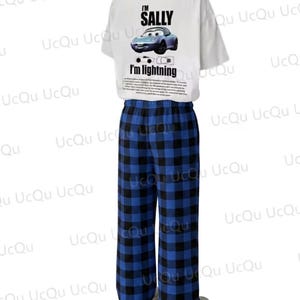 May include: A white short-sleeved t-shirt featuring a graphic of a blue car with the text I'M SALLY and I'M LIGHTNING, paired with blue and black plaid pajama pants. The shirt includes a small car illustration and a block of small printed text.
