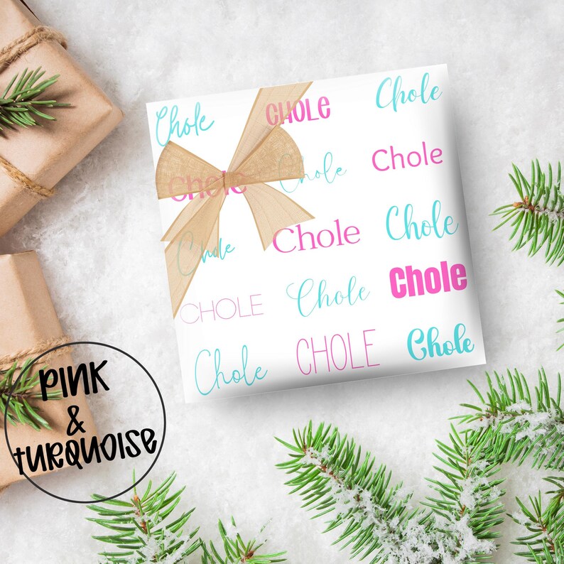 May include: White gift wrap with the word "Chole" in pink and turquoise script. A tan ribbon bow adorns the wrapped gift. The words "Pink & Turquoise" are in a black circle in the lower left corner. Green pine branches are in the background.