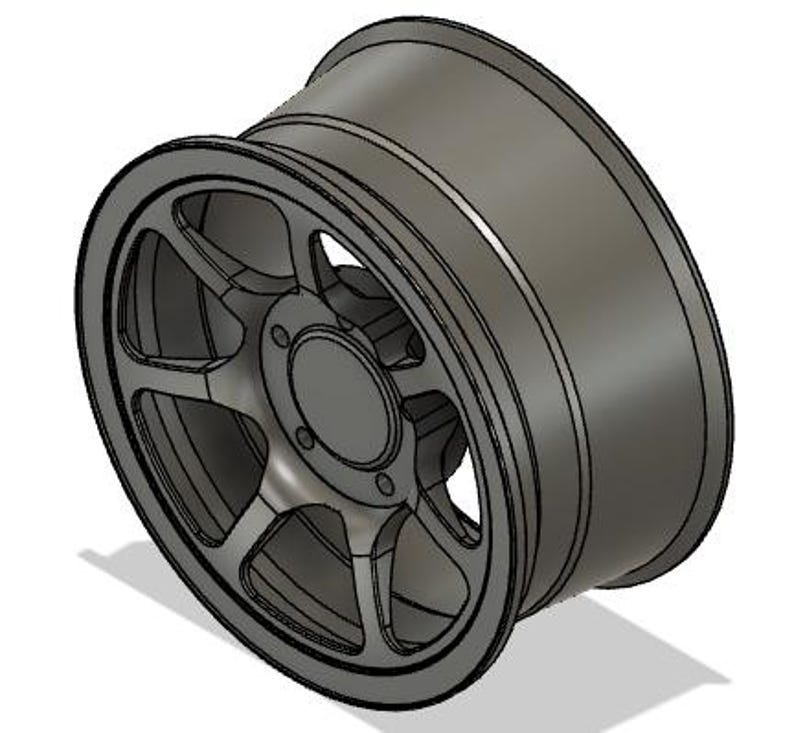 May include: A gray alloy wheel with a multi-spoke design. The wheel has a central hub with bolt holes and a deep dish profile. The rim is a dark gray color, and the wheel appears to be new.