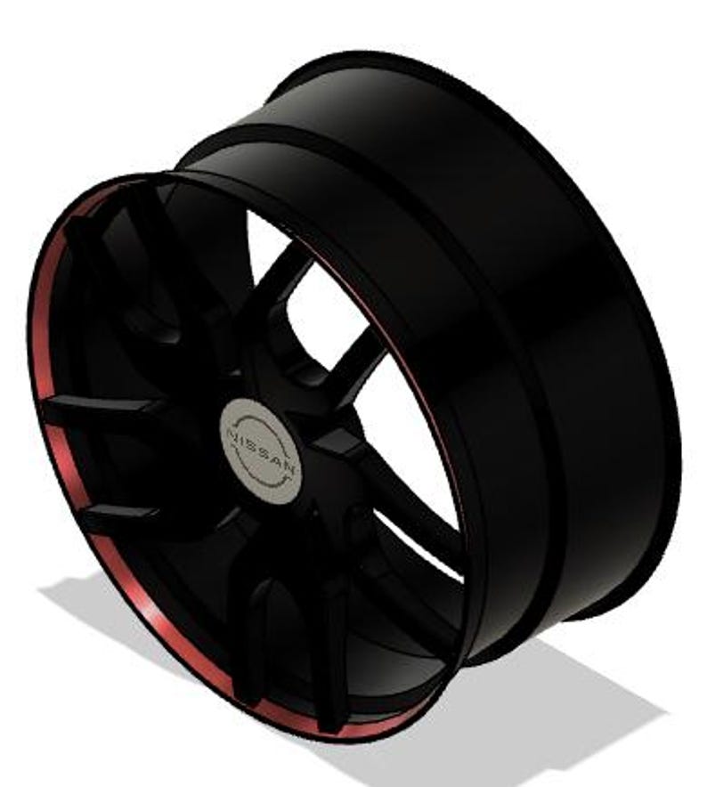 May include: Black alloy wheel with a red accent on the rim. The wheel has a multi-spoke design and a silver center cap with the Nissan logo. The wheel is angled, showing its depth and design.