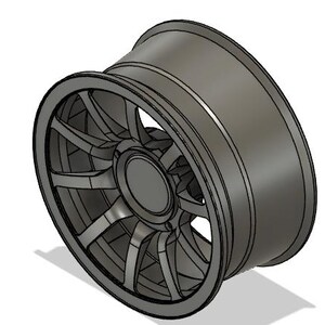 May include: A gray alloy wheel with a multi-spoke design. The wheel has a rounded outer rim and a central hub. The spokes are evenly spaced and connect the hub to the rim. The wheel is designed for a vehicle.