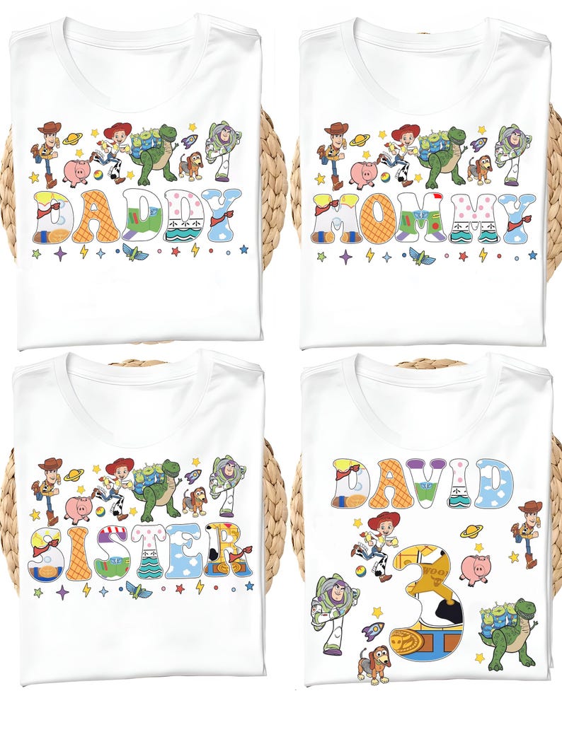 May include: Four white t-shirts with colorful graphics. Each shirt features a different name: "DADDY", "MOMMY", "SISTER", and "DAVID". The designs include cartoon characters and decorative elements.